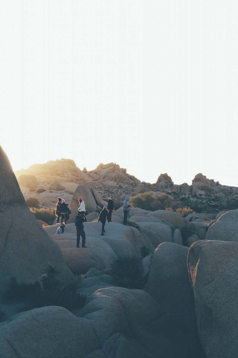 group people standing on rock formations during daytime explore